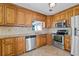 Kitchen featuring wood cabinets, stainless steel appliances, and ceramic tile floors at 297 Northgate Trce, Roswell, GA 30075