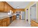Traditional eat-in kitchen with wooden cabinets, granite countertops, and stainless steel appliances at 297 Northgate Trce, Roswell, GA 30075