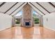 Bright living room with vaulted ceiling, wood beams, fireplace, and hardwood floors at 297 Northgate Trce, Roswell, GA 30075
