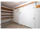 Basement storage area with shelving and a white door, offering organization at 297 Northgate Trce, Roswell, GA 30075
