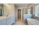 Modern bathroom featuring double sink vanity, glass enclosed shower, and freestanding tub at 308 Delta Dr, Mcdonough, GA 30253