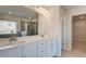 Modern bathroom featuring double sink vanity, a window, and entry to the walk-in closet at 308 Delta Dr, Mcdonough, GA 30253