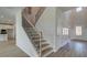 Elegant staircase with metal balusters, wood treads, and an inviting entryway at 308 Delta Dr, Mcdonough, GA 30253