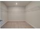 An empty walk-in closet with wire shelving and neutral carpeting, ready for customization at 308 Delta Dr, Mcdonough, GA 30253