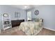Cozy bedroom with light blue walls and a plush floral patterned quilt at 516 Huntgate Rd, Woodstock, GA 30189