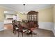 Traditional dining room with a wooden table and chairs, elegant china cabinet, and classic decor at 516 Huntgate Rd, Woodstock, GA 30189