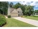Well-maintained two-story home with a lush green lawn and a spacious driveway leading to a two-car garage at 516 Huntgate Rd, Woodstock, GA 30189