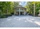 Unique home exterior with a large deck surrounded by trees at 516 Huntgate Rd, Woodstock, GA 30189