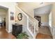 Bright foyer showcasing staircase, decor table, and adjacent dining area at 516 Huntgate Rd, Woodstock, GA 30189