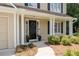 Inviting front porch with decorative wreath, landscaping, and elegant columns for added curb appeal at 516 Huntgate Rd, Woodstock, GA 30189