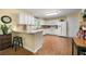 Bright kitchen features white cabinets, granite countertops, and stainless-steel appliances at 516 Huntgate Rd, Woodstock, GA 30189
