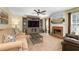 Spacious living room with brick fireplace, ceiling fan, and large built-in entertainment center at 516 Huntgate Rd, Woodstock, GA 30189