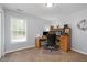 Comfortable home office with a large window, desk, ample storage, and a neutral color scheme at 516 Huntgate Rd, Woodstock, GA 30189