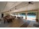 Covered outdoor area with tables and chairs overlooking the pool at 516 Huntgate Rd, Woodstock, GA 30189