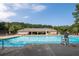 Community pool with plenty of lounge chairs and a lifeguard stand at 516 Huntgate Rd, Woodstock, GA 30189