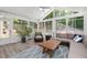 Bright sunroom with lots of light features a ceiling fan and views of the backyard at 516 Huntgate Rd, Woodstock, GA 30189