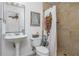 Well-lit bathroom featuring a sink, toilet, decorative art, and tiled walk-in shower at 1304 Liberty Nw Pkwy # 1610, Atlanta, GA 30318