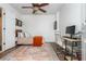 Comfortable bedroom with ceiling fan, bed, desk, neutral walls, and colorful area rug at 1304 Liberty Nw Pkwy # 1610, Atlanta, GA 30318