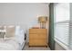 Well lit bedroom features a wooden dresser, decorative lamp and nice window at 1304 Liberty Nw Pkwy # 1610, Atlanta, GA 30318
