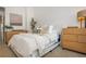 Serene bedroom with neutral tones, wood furniture, a comfortable bed, and lots of natural light at 1304 Liberty Nw Pkwy # 1610, Atlanta, GA 30318