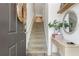Welcoming entryway showcasing the staircase, neutral paint, console table, and decorative accents at 1304 Liberty Nw Pkwy # 1610, Atlanta, GA 30318