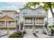 Charming townhome exterior with a two-car garage, beautiful landscaping, and inviting front porch at 1304 Liberty Nw Pkwy # 1610, Atlanta, GA 30318