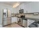 Well-lit kitchen with stainless steel appliances, stone countertops, and white cabinetry at 1304 Liberty Nw Pkwy # 1610, Atlanta, GA 30318