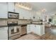 Well-appointed kitchen with stainless appliances and a view of the living room at 1304 Liberty Nw Pkwy # 1610, Atlanta, GA 30318