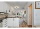 White kitchen with tile backsplash flowing into entry with wooden floor at 1304 Liberty Nw Pkwy # 1610, Atlanta, GA 30318