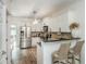 Modern kitchen featuring stainless steel appliances, granite countertops, ample white cabinetry, and an open bar area with seating at 1304 Liberty Nw Pkwy # 1610, Atlanta, GA 30318
