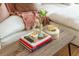 Close up of a modern coffee table with books and decorations, adding charm to the living area at 1304 Liberty Nw Pkwy # 1610, Atlanta, GA 30318
