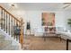Bright living room with hardwood floors, a neutral sofa, stairs, and stylish decor at 1304 Liberty Nw Pkwy # 1610, Atlanta, GA 30318