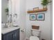 Cozy half bathroom with a modern vanity, floating shelves, and decorative artwork at 1304 Liberty Nw Pkwy # 1610, Atlanta, GA 30318