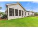 Charming rear of home with screened in patio, lush green lawn, and manicured landscaping at 2335 Plummer Sw Pl, Marietta, GA 30064