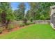 Large backyard featuring a well-maintained lawn, privacy fence, and mature trees at 2335 Plummer Sw Pl, Marietta, GA 30064