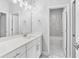 Bright bathroom boasts double vanity, sleek fixtures, and marble-tiled shower at 2335 Plummer Sw Pl, Marietta, GA 30064
