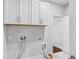 Bright laundry room featuring white cabinetry and modern fixtures at 2335 Plummer Sw Pl, Marietta, GA 30064
