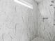 Contemporary shower with marble tile, built-in bench, and showerhead at 2335 Plummer Sw Pl, Marietta, GA 30064