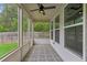 Relaxing sunroom with stylish tile flooring, ceiling fan, and view of the backyard at 2335 Plummer Sw Pl, Marietta, GA 30064