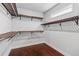 Functional walk-in closet with custom shelving, hardwood floors, and window at 2335 Plummer Sw Pl, Marietta, GA 30064