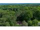 Expansive aerial view of the property, surrounded by a lush green forest landscape and Atlanta's skyline in the distance at 2674 Skylane Dr, Marietta, GA 30062