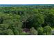 Aerial view showcasing expansive greenery and tree canopy over quiet, residential home at 2674 Skylane Dr, Marietta, GA 30062
