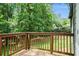 Spacious back deck with wood railing offering scenic views of the surrounding greenery at 2674 Skylane Dr, Marietta, GA 30062