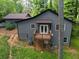 Rear exterior view of home with a cozy wooden deck, gray siding, and lush greenery in the backyard at 2674 Skylane Dr, Marietta, GA 30062