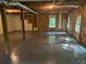 Unfinished basement showing concrete floor, exposed beams, natural light from window and exposed utilities at 2674 Skylane Dr, Marietta, GA 30062
