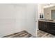 Half bath with dark wood cabinets, granite countertops, and wood-look flooring at 2674 Skylane Dr, Marietta, GA 30062