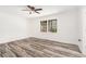 Bright bedroom with wood-look floors, white walls, and large window overlooking the backyard at 2674 Skylane Dr, Marietta, GA 30062