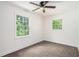 Bright bedroom with natural light, neutral carpet, and a ceiling fan for added comfort at 2674 Skylane Dr, Marietta, GA 30062