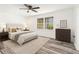 Cozy bedroom with wood-look floors, ceiling fan, and ample natural light at 2674 Skylane Dr, Marietta, GA 30062