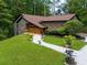 Charming front yard of home featuring manicured landscaping, a stone walkway, and lovely curb appeal at 2674 Skylane Dr, Marietta, GA 30062